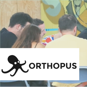 Un groupe collabore autour d'une table dans un espace créatif avec décorations colorées, et le logo "Orthopus" avec une pieuvre noire en avant-plan.